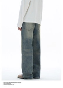 Detailed back view of vintage wash wide-leg denim jeans with retro whiskered texture