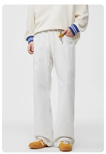 Détail du pantalon en maille gris clair avec cordon de serrage et boutons décoratifs