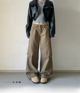 Detail view of khaki wide-leg cargo pants with large side pockets and cotton twill fabric