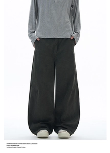 Detail of dark gray washed cotton trousers with deconstructed seams and loose fit