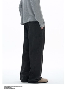 Detail of grey wide-leg workwear trousers with washed texture and large back pockets
