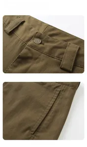 Detail of brown twill work pants showing fabric texture and vintage star metal button