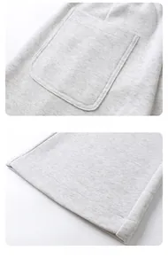 Détails de la poche arrière et des poignets à double couture du pantalon de sport gris