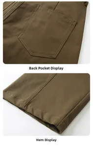 Detailed close-up of rear patch pockets and hem stitching on durable work trousers