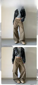 Detailed view of khaki wide-leg cargo pants styled with a black leather biker jacket