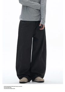 Detailed view of dark grey wide-leg cargo pants with knee darts and stitching craftsmanship