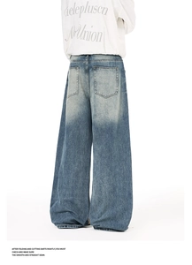 Detailed back view of wide-leg blue denim jeans featuring large patch pockets and washed texture