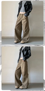 Close-up of wide-leg cargo pants featuring vintage stonewashed fabric and side flap pockets