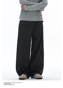 Detailed close-up showing deconstructed dart stitching on black wide-leg work trousers