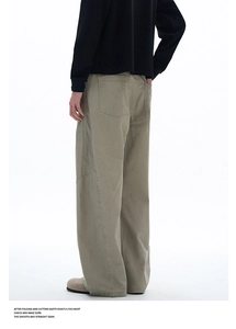 Detail view of khaki work trousers featuring wide-leg cut and heavy twill fabric texture