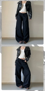 Macro detail of baggy cargo trousers paired with a cropped faux leather jacket and white tank top