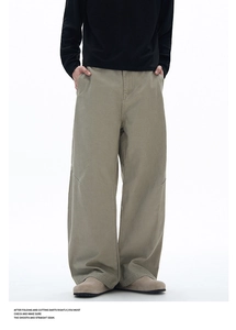 Detailed view of the tailored knee darts and twill texture on men's khaki wide-leg trousers