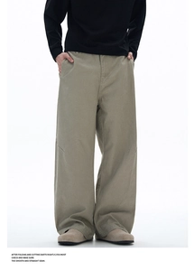 Detail of khakis wide-leg cargo pants showing deconstructed seams and knee pleats