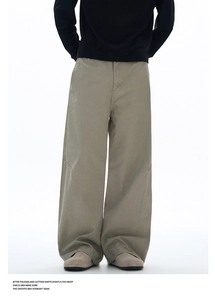 Detail view of the straight seams and smooth fabric finish of men's wide-leg khaki trousers