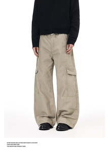 Detail view of khaki wide-leg cargo pants with flap pockets and reinforced stitching