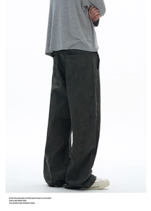 Rear view of loose fit charcoal cargo pants with structural seams and large pockets