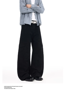 Detail view of mens black wide-leg cargo pants with large side flap pockets and twill fabric