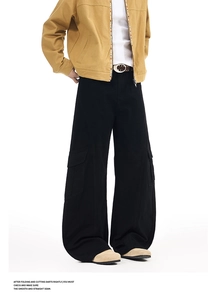 Detail view of black vintage cargo pants featuring spacious utility pockets and relaxed fit