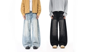 Detail of vintage high street baggy jeans with wash fading and metal D-buckle belt