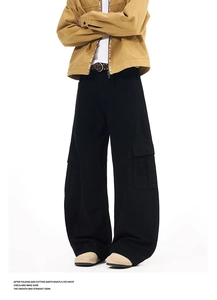 Detail showing the wide-leg cut and functional cargo pockets of the black street trousers