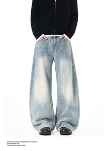 Macro shot of vintage washed light blue wide leg jeans with street style stacked cuff detail