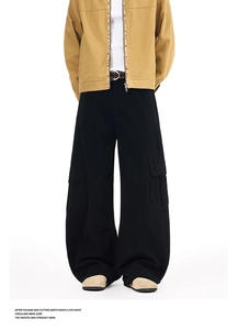 Detail of loose black cargo pants with multiple pockets in retro street style design