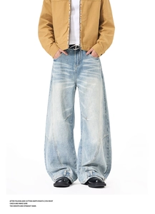 Detailed close-up of light blue baggy jeans with vintage wash and unique seam design