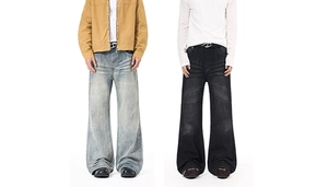 Detail of vintage washed denim with retro whiskers and loose flared fit for men
