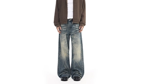 Detail view of vintage washed straight denim pants with cat whiskers and retro fading
