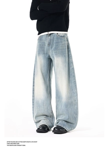 Detail view of high street retro washed denim jeans with heavy fading and stacked leg effect