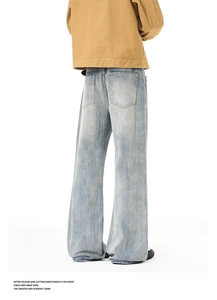 Detail of vintage washed denim jeans with large back pockets and high-street flared fit