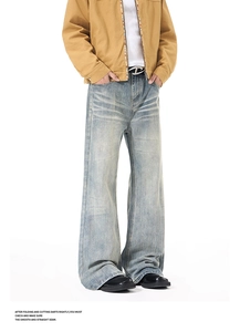 Detailed close-up of vintage washed denim jeans with whisker textures and distressed finish