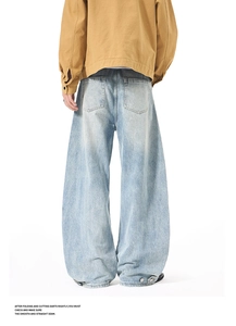 Rear view of baggy light wash denim jeans featuring adjustable button hem and wide leg cut