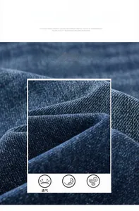 Vista macro del tessuto denim blu scuro con trama a saia distinta e finitura morbida