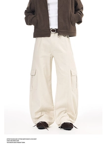 Detail shot of vintage washed cream cargo pants with large flap pockets and wide leg cut