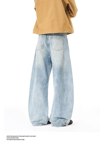 Close-up of light blue washed baggy denim jeans with rear pockets and workwear details