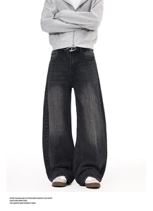Detailed view of dark grey washed slub cotton fabric texture on wide leg denim pants