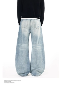 Back view of light blue wide-leg jeans featuring distressed wash and oversized fit