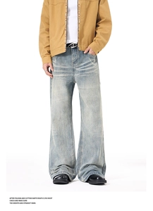 Detail of light blue washed denim jeans with vintage whiskering and flared leg cut