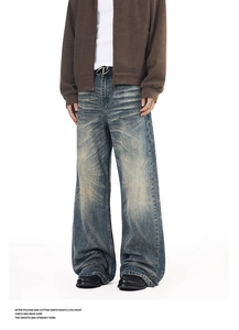 Detail of vintage washed blue straight leg jeans with whiskers and stacked ankles