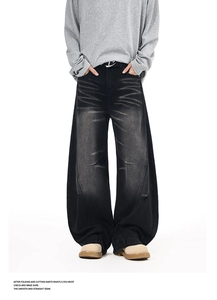Detailed macro view of retro washed black wide-leg jeans with distressed whiskers and textures