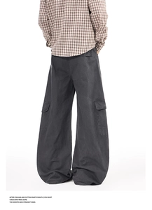Macro view of wide-leg cargo pants in charcoal grey with vintage utility flap pockets