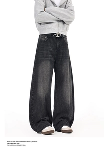 Detailed close-up of vintage washed grey flared jeans with signature D-logo metal belt