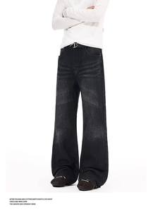 Macro detail of washed black vintage flare jeans with cat-whisker texture and belt