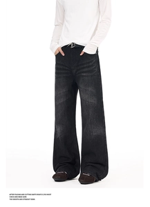 Detail of vintage washed grey flared jeans showing whiskered fading and high-waist fit