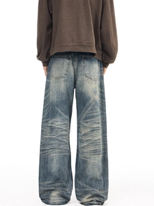 Retro washed baggy denim jeans with whiskered fading and high street vintage style