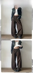 Detail view of American vintage brown wide-leg pants with metal rivet pocket accents
