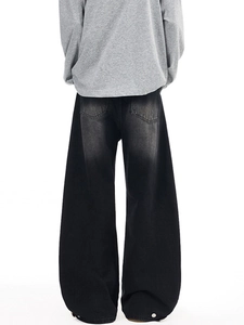 Oversized street style back view of vintage wash wide leg jeans with a grey sweatshirt