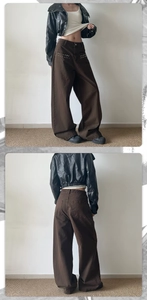 Detail of metal star rivets on pockets of vintage brown wide-leg baggy trousers