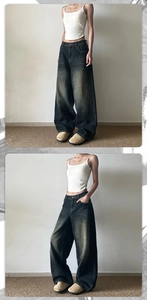 Détail d'un jean large à taille haute avec délavage vintage et coupe ample et fluide
